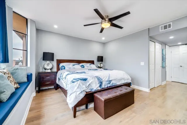a bedroom with a bed window and a ceiling fan