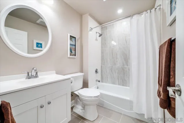 a bathroom with a toilet a sink and a mirror