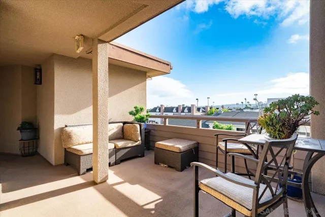 a view of a hallway with furniture and a livingroom