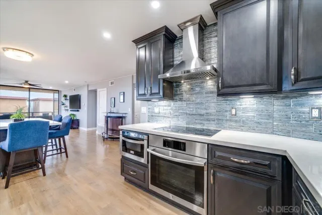 a kitchen with stainless steel appliances granite countertop a stove a sink and a microwave