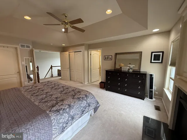 a spacious bathroom with a double vanity sink large mirror and a bathtub