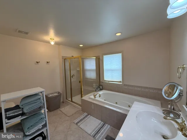 a bath room with a bath tub and a sink