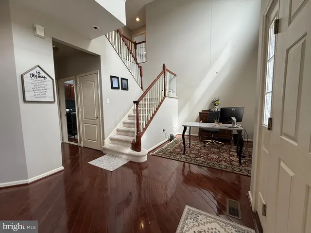 a view of entryway and hall with wooden floor