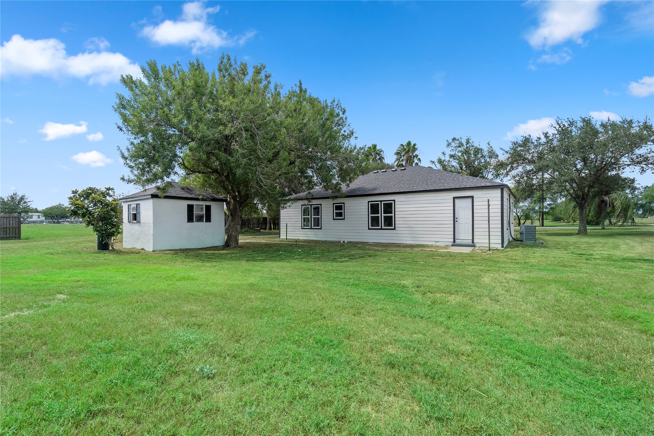 16752 Rio Rancho Road Harlingen, TX 78552 - Photo 20 of 25 a front view of a house with a garden