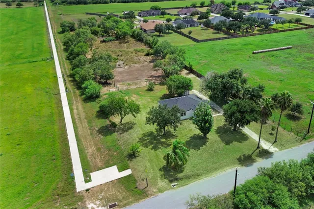 an aerial view of a golf course with a lake view