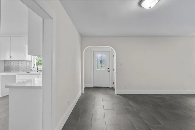 a view of a livingroom with wooden floor and a window