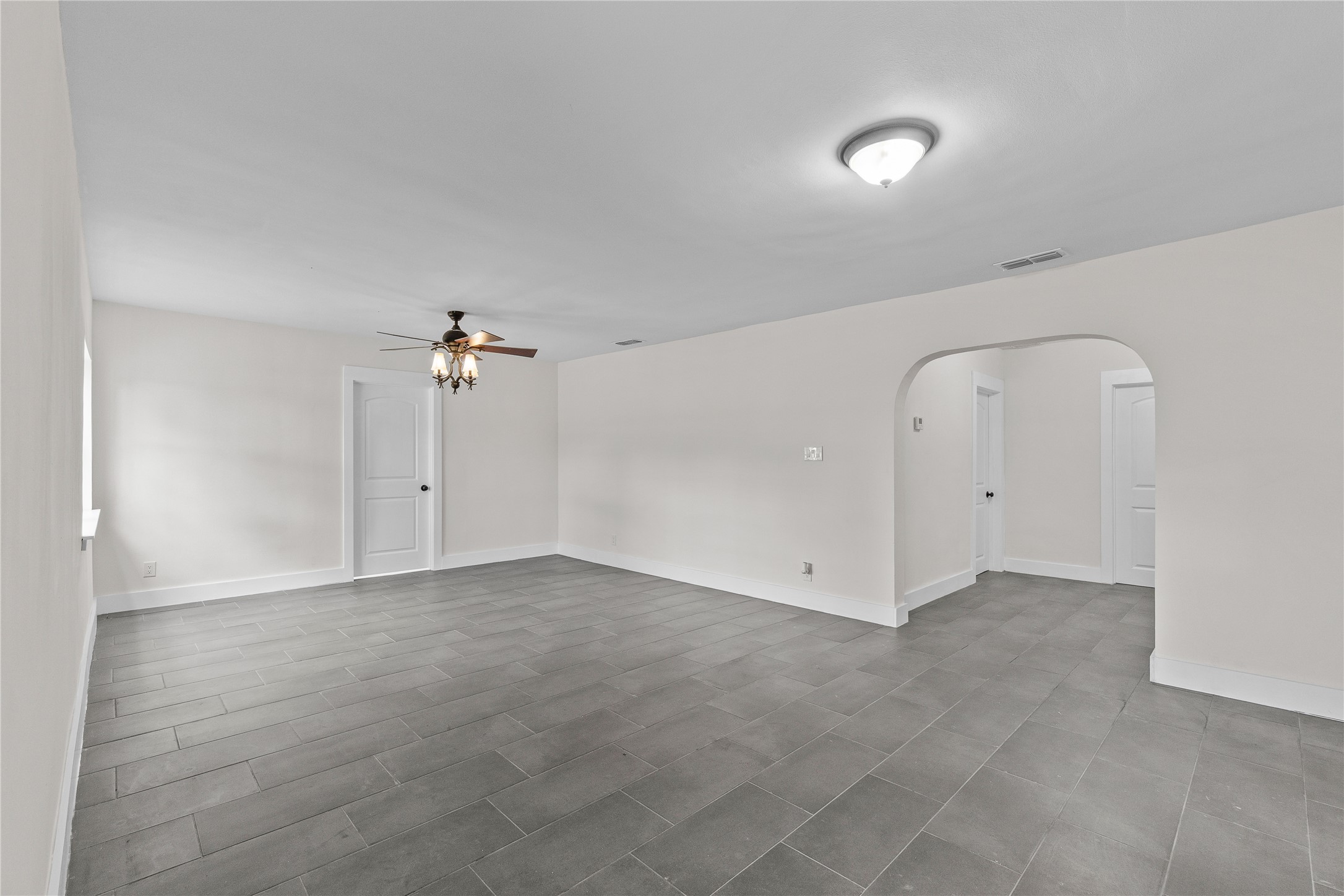 16752 Rio Rancho Road Harlingen, TX 78552 - Photo 5 of 25 an empty room with a ceiling fan and a window