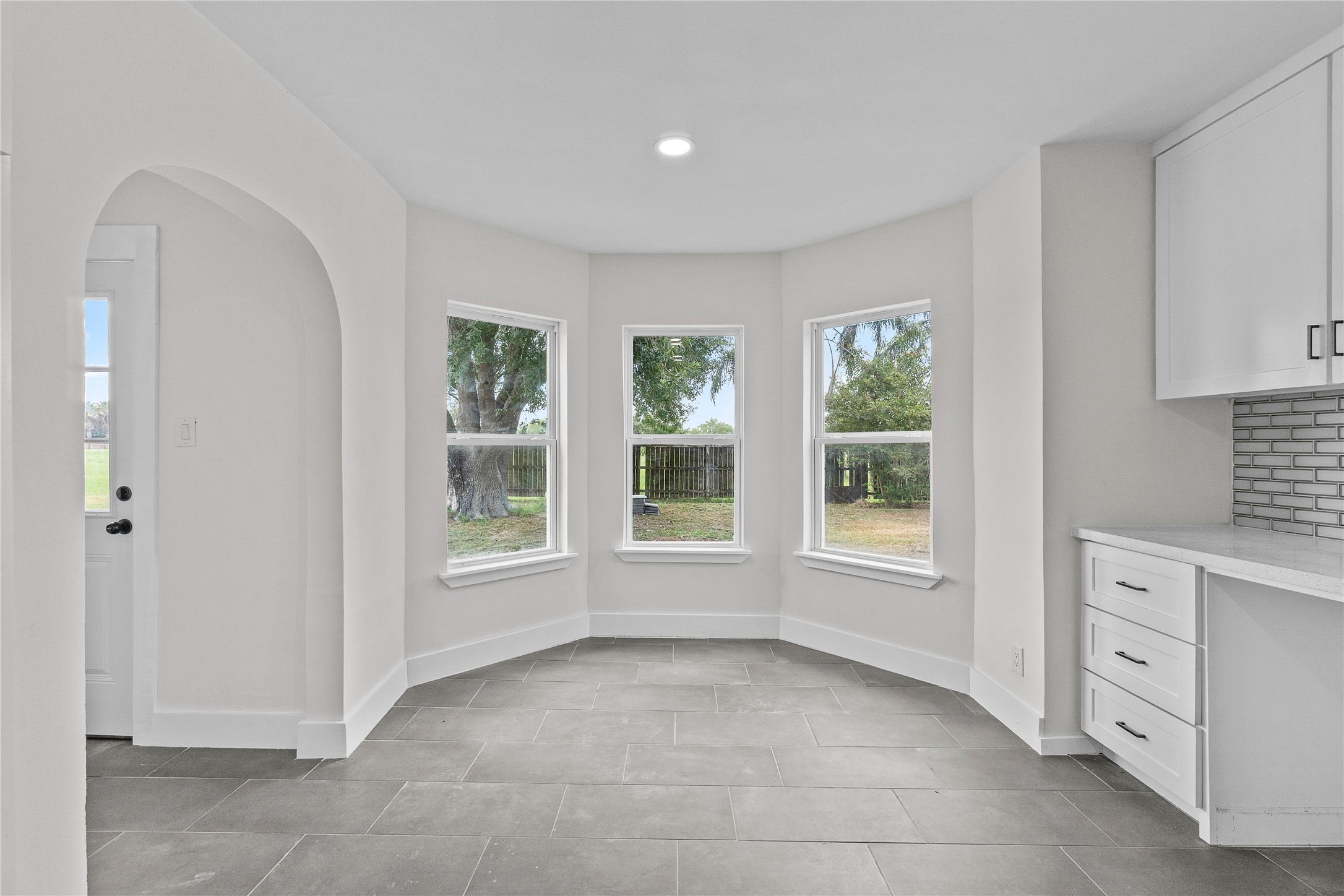 16752 Rio Rancho Road Harlingen, TX 78552 - Photo 8 of 25 a view of an empty room with a window and kitchen view