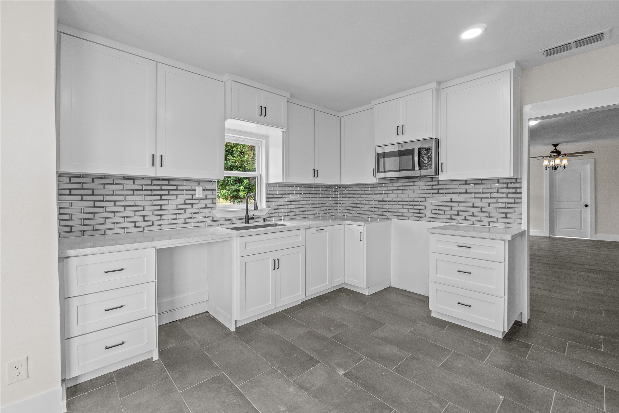 16752 Rio Rancho Road Harlingen, TX 78552 - Photo 10 of 25 a kitchen with cabinets appliances and a window