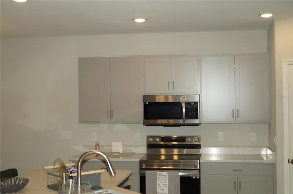 a kitchen with a sink and a microwave