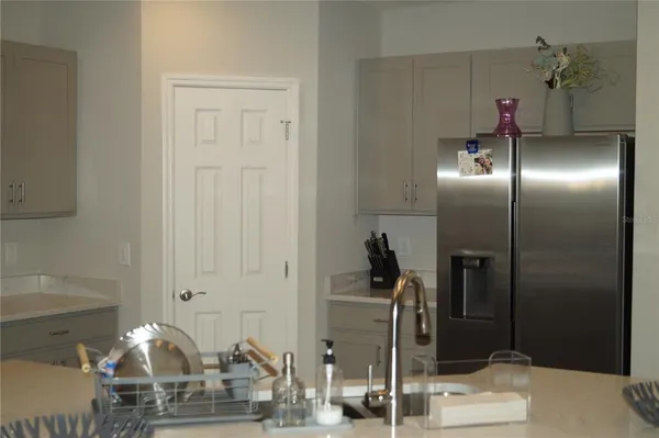 a kitchen with stainless steel appliances kitchen island granite countertop a refrigerator and a stove top oven