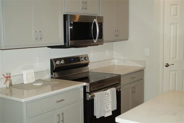 a kitchen with sink cabinets and microwave