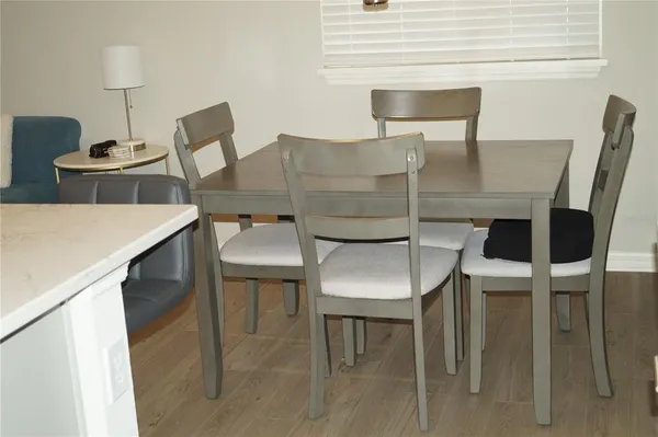 a kitchen with a table chairs and a table