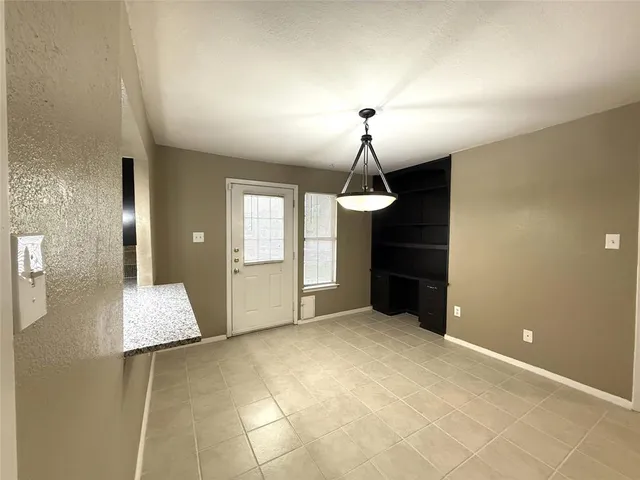 a view of empty room with a sink and chandelier