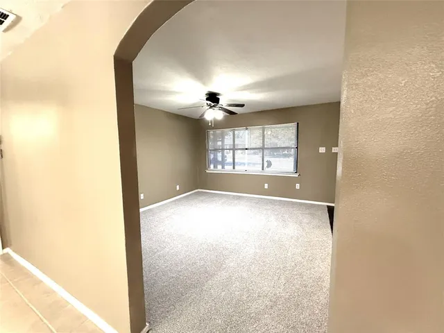 an empty room with a empty space and windows