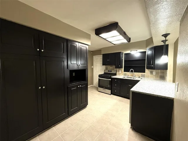 a kitchen with a refrigerator and a sink