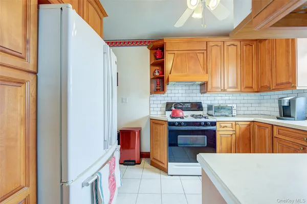 a kitchen with stainless steel appliances granite countertop a sink and a refrigerator