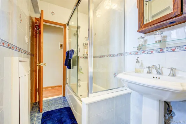 a bathroom with a sink a mirror and shower