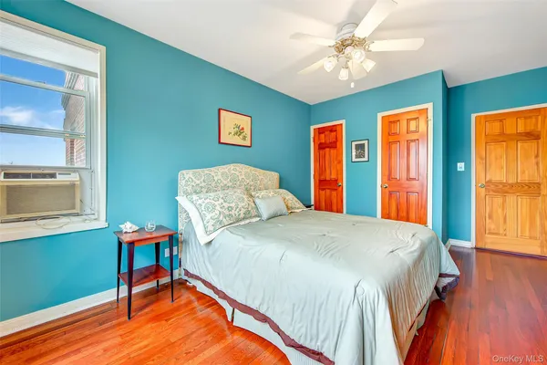 a bedroom with a bed dresser and a window