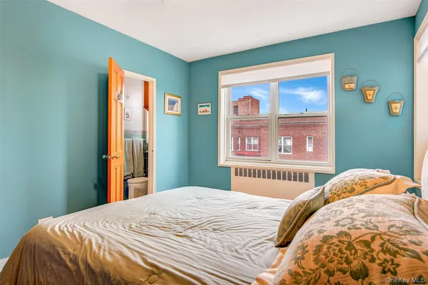 a bedroom with a bed and a large mirror