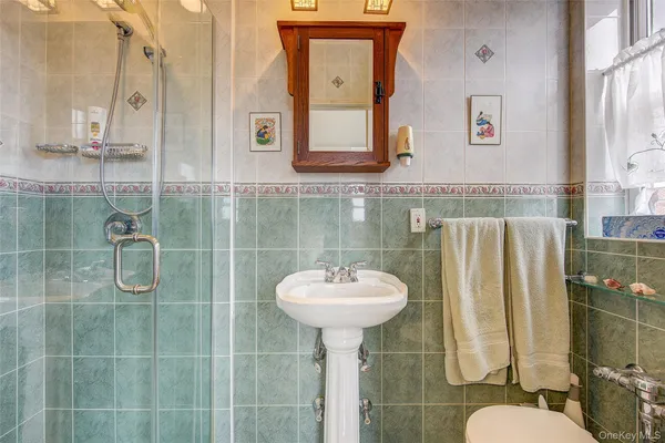 a bathroom with a sink mirror and toilet