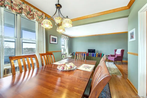 a view of a dining room with furniture and a chandelier