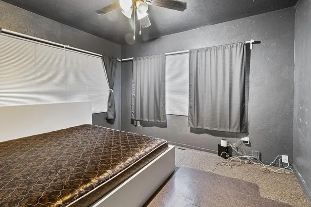 an empty room with fan and entrance