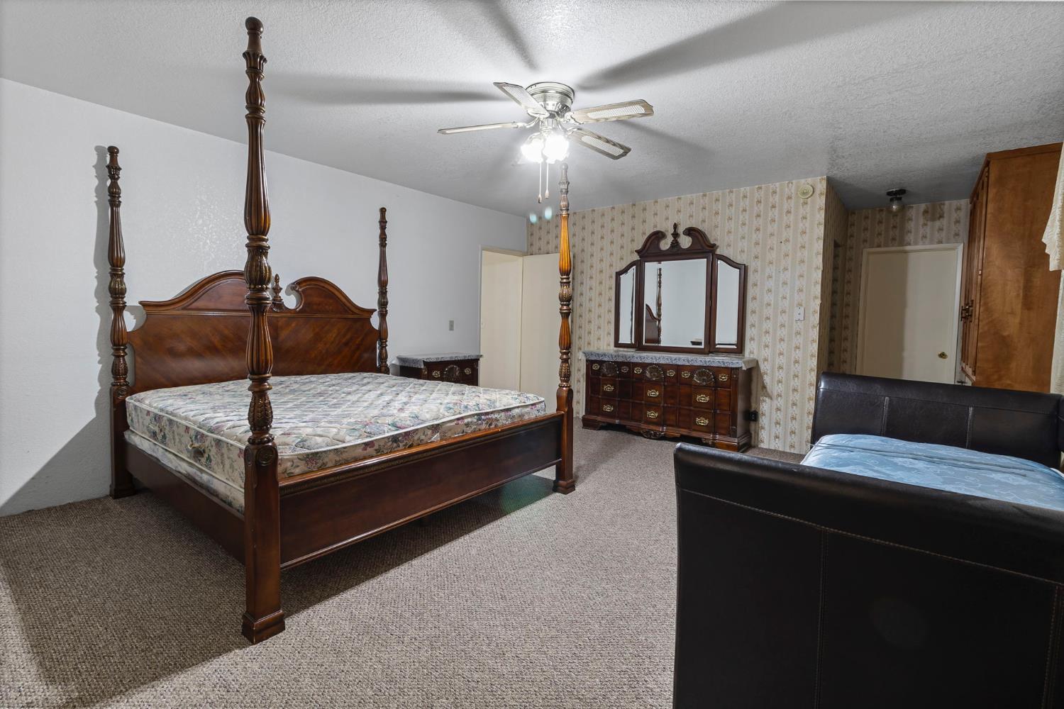 5000 Nunes Road Turlock, CA 95382 - Photo 51 of 57 a bedroom with a bed and dresser with mirror