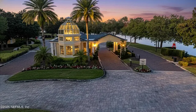a view of a house with a yard and potted plants