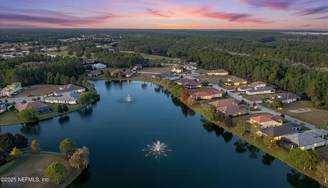 an aerial view of a house with a lake view