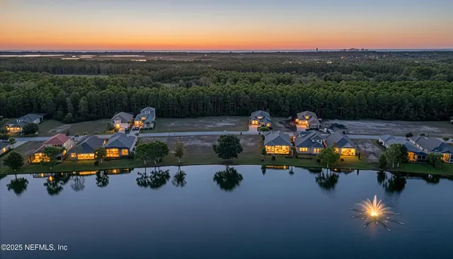 an aerial view of a city with lots of residential buildings ocean and mountain view