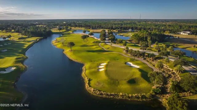 an aerial view of a swimming pool with outdoor seating