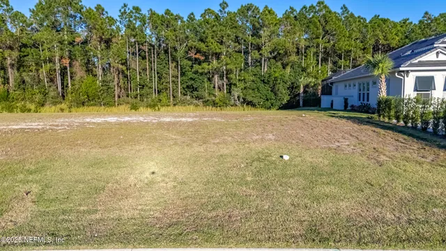 a view of a house with a yard and tree