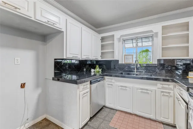 a kitchen with stainless steel appliances granite countertop a sink a stove and cabinets