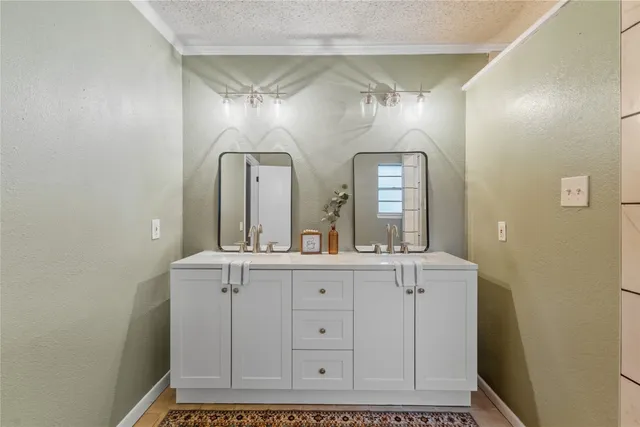 a spacious bathroom with a double vanity sink and a mirror