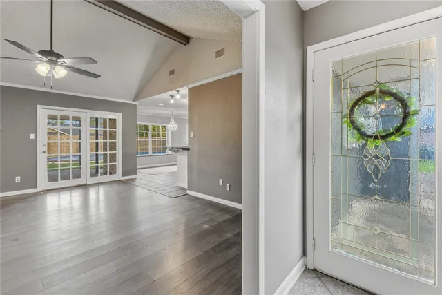 a view of an entryway with wooden floor