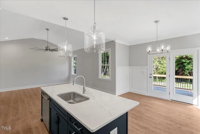 a kitchen that has a kitchen island wooden floor and a window