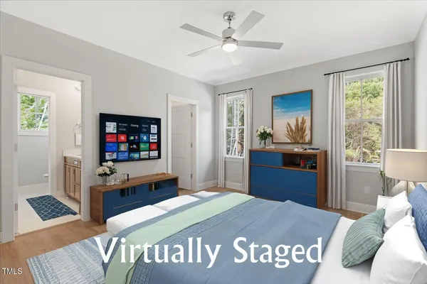 a bedroom with a bed and a flat screen television