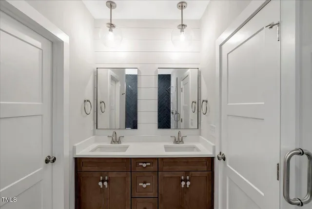 a bathroom with a double vanity sink and a mirror
