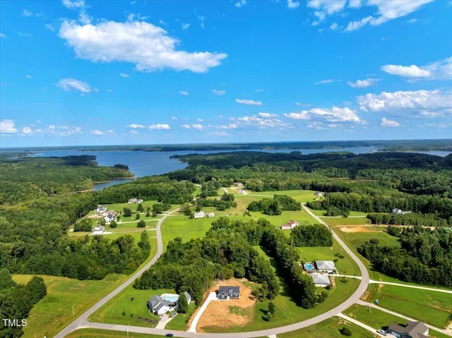 a front view of a house with yard and trees