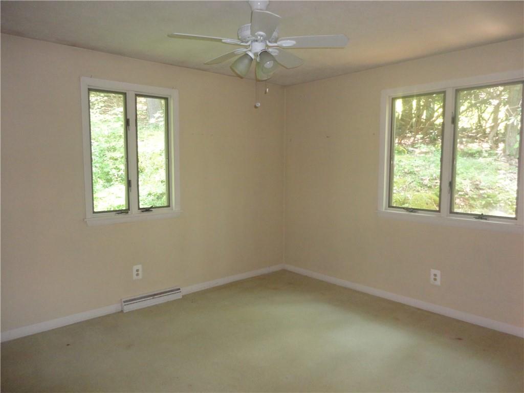 3202 Listonburg Road Confluence, PA 15424 - Photo 11 of 26 an empty room with a window and a fan