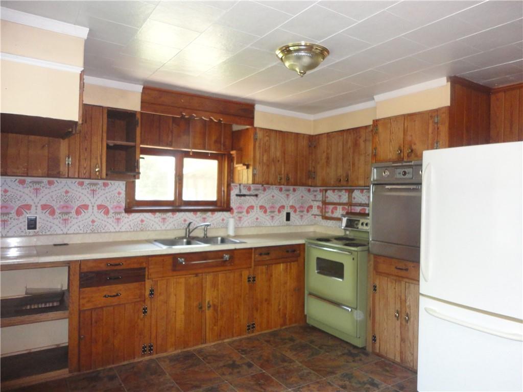3202 Listonburg Road Confluence, PA 15424 - Photo 3 of 26 a kitchen with a sink stove and refrigerator