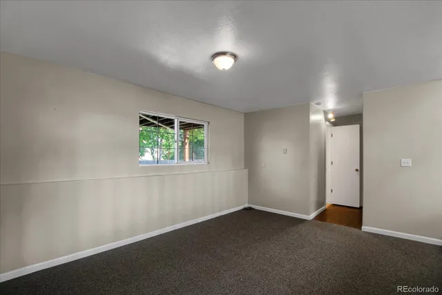 a bathroom with a granite countertop sink toilet and mirror