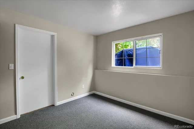 a view of a house with backyard and trees
