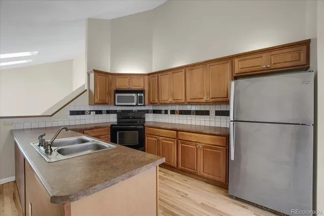 a kitchen with a sink a stove and refrigerator