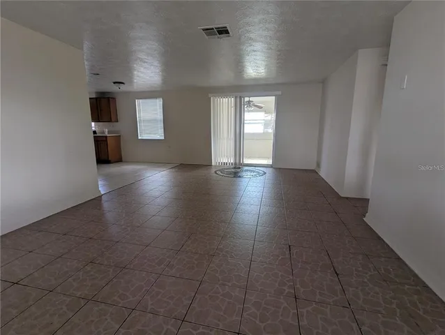 an empty room with windows and entrance