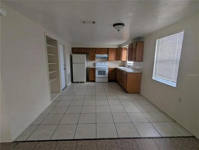 a view of a kitchen with furniture and window