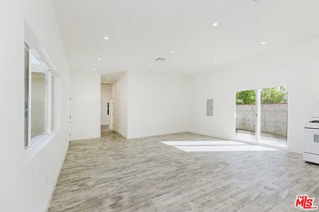 a view of an empty room with a sliding door