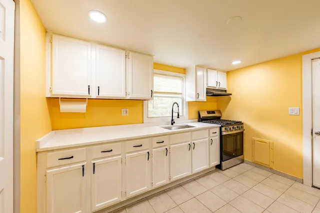 a kitchen with stainless steel appliances granite countertop a sink and cabinets