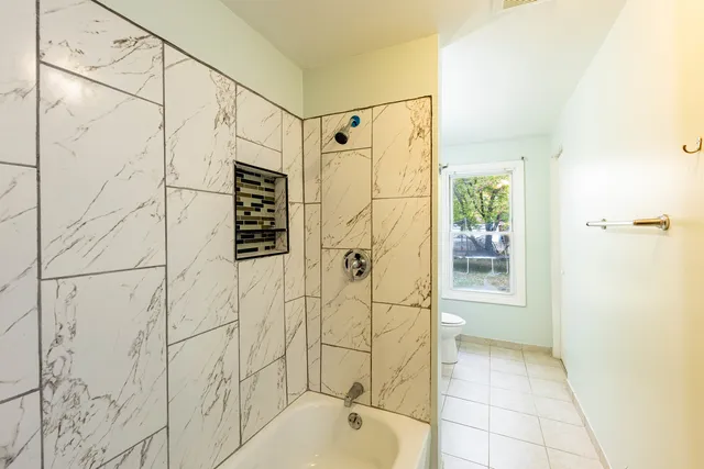 a bathroom with a shower and a bathtub